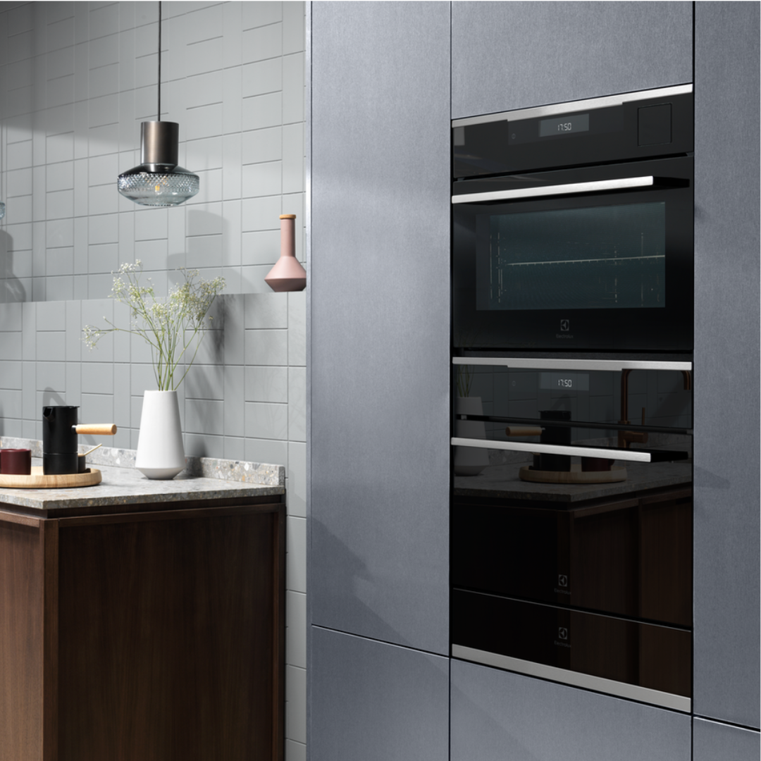 Modern kitchen with gray cabinets and Electrolux 600 Series Built In Warming Drawer