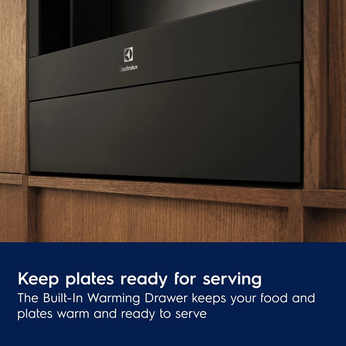 Electrolux built-in warming drawer in a kitchen setting with text about keeping plates ready for serving.