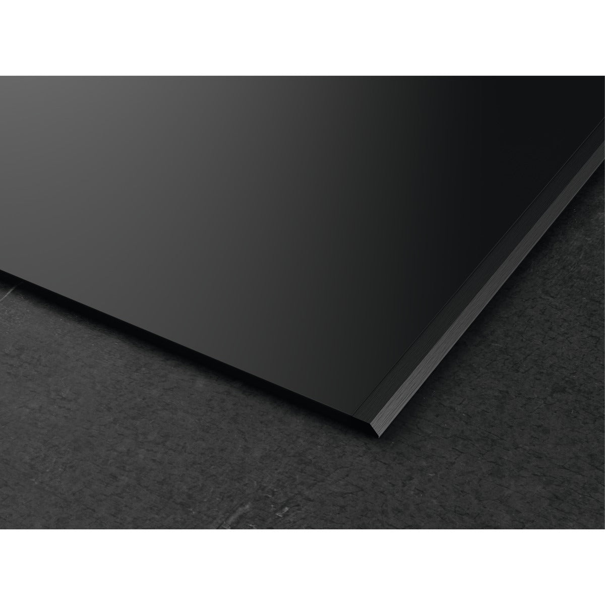 Black rectangular sheet on a textured black surface