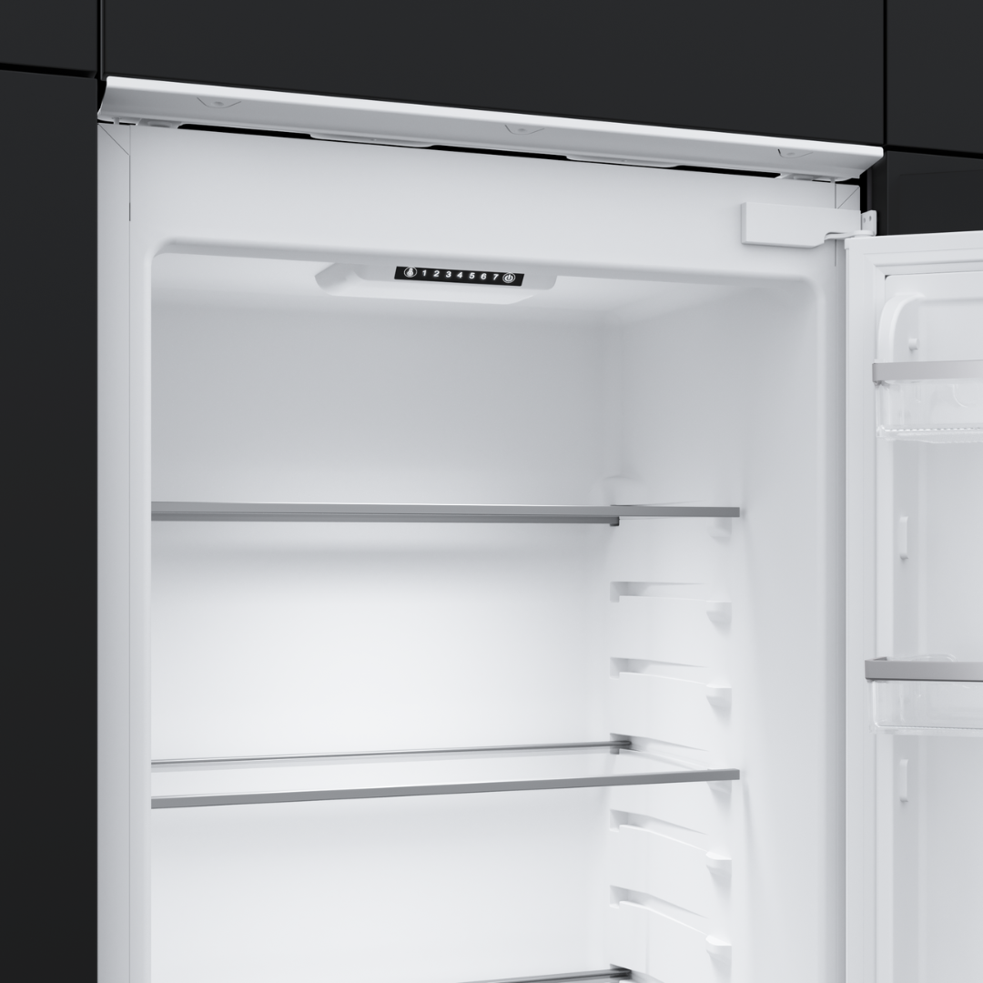 Empty TEKA refrigerator with open door on a black background