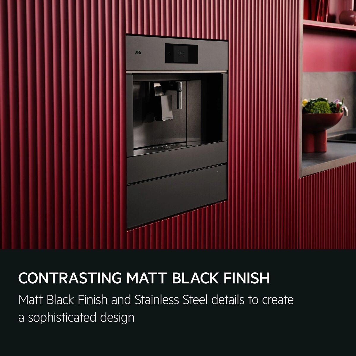 Modern kitchen setup with a black AEG Integrated Coffee Machine against a red textured wall.