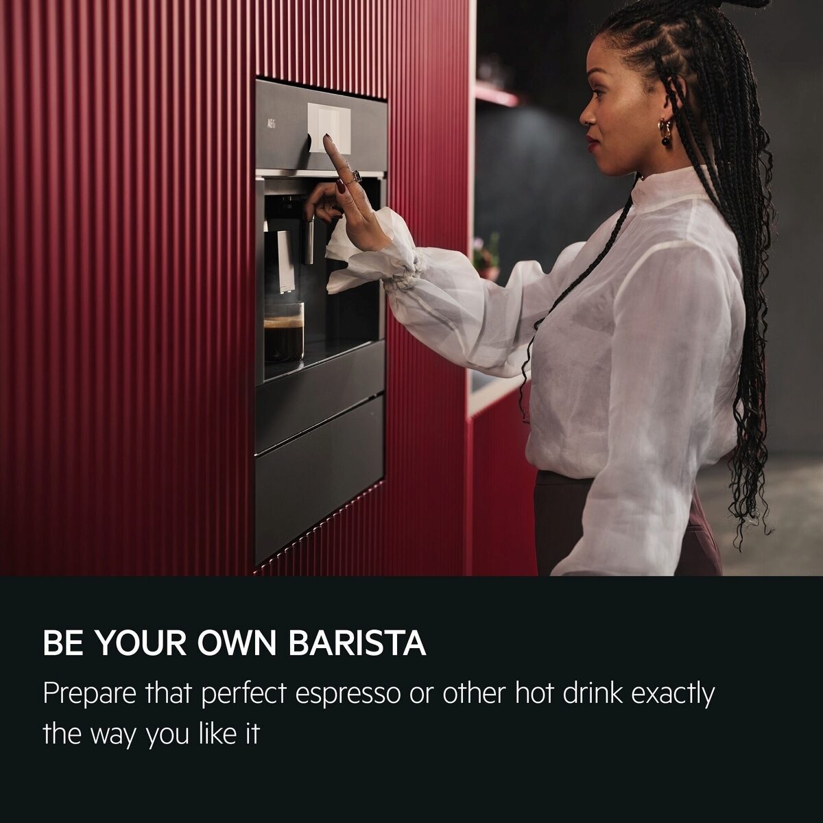 Woman using an AEG Integrated coffee machine with text 'Be your own barista' and 'Prepare that perfect espresso or other hot drink exactly the way you like it'.
