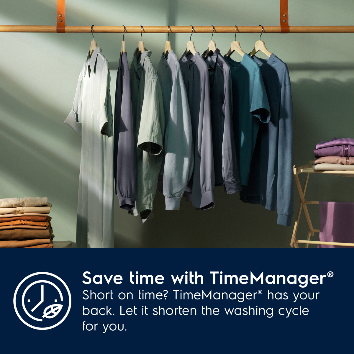 Clothing hanging on a rack with promotional text for Electrolux TimeManager washing machine.