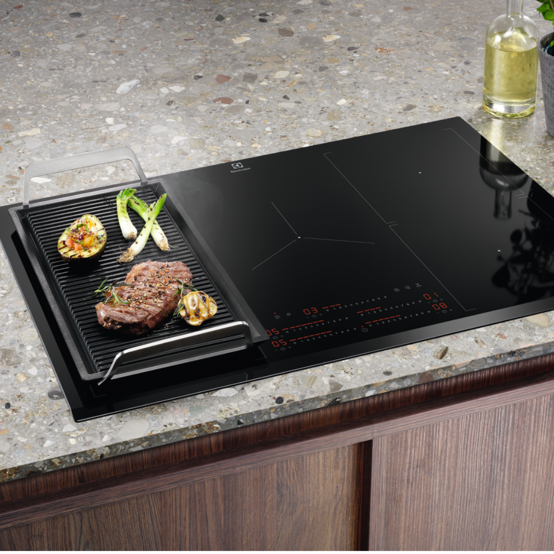 Electrolux Black induction Hob with a grill pan on a kitchen counter