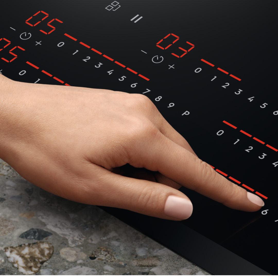 Hand interacting with a Electrolux Black induction Hob 