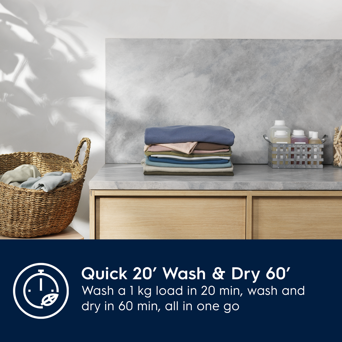 Laundry setup with folded clothes, a basket, and a dryer on a countertop with a gray wall background.