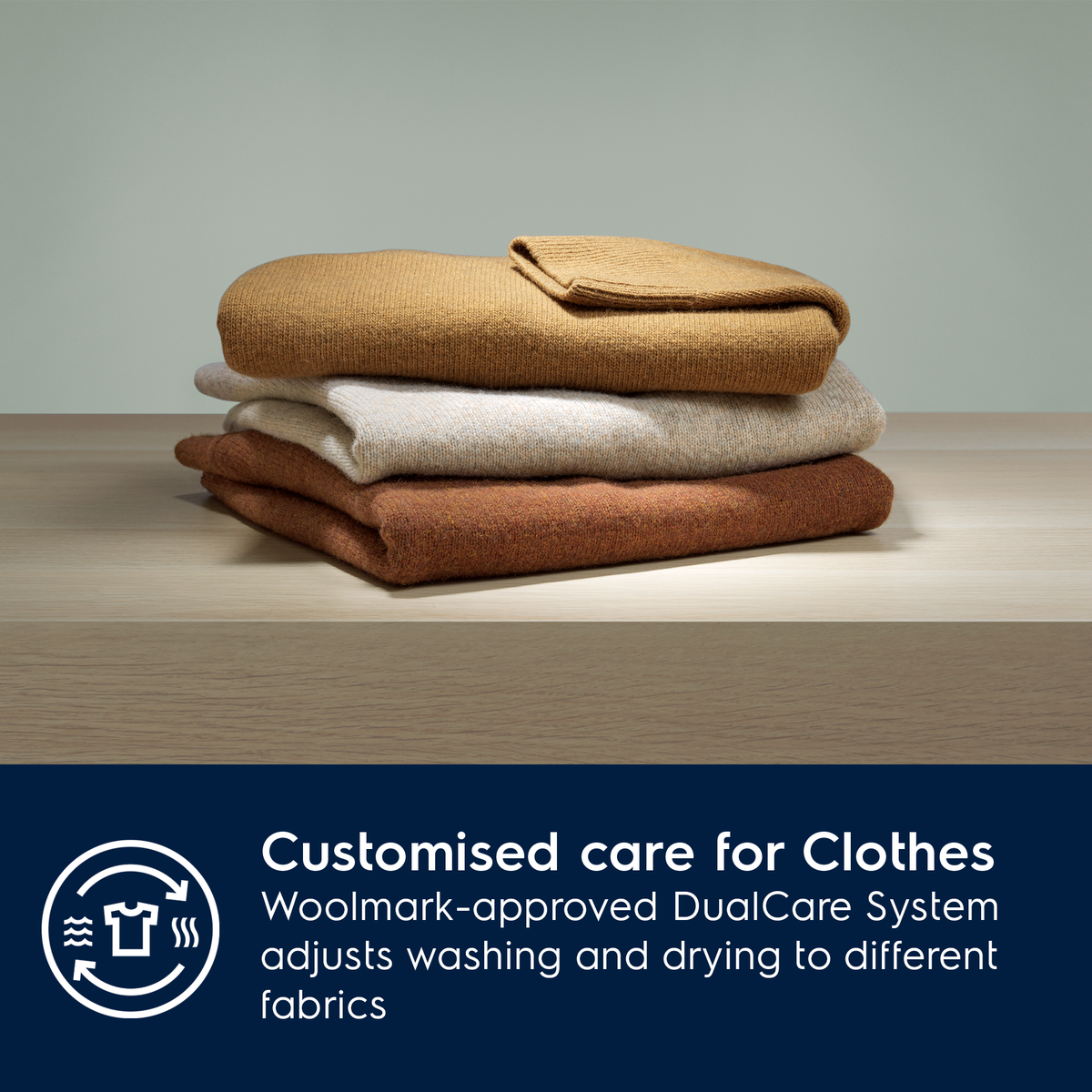 Stack of folded clothes on a wooden surface with a text overlay about Electrolux Woolmark-approved DualCare System.
