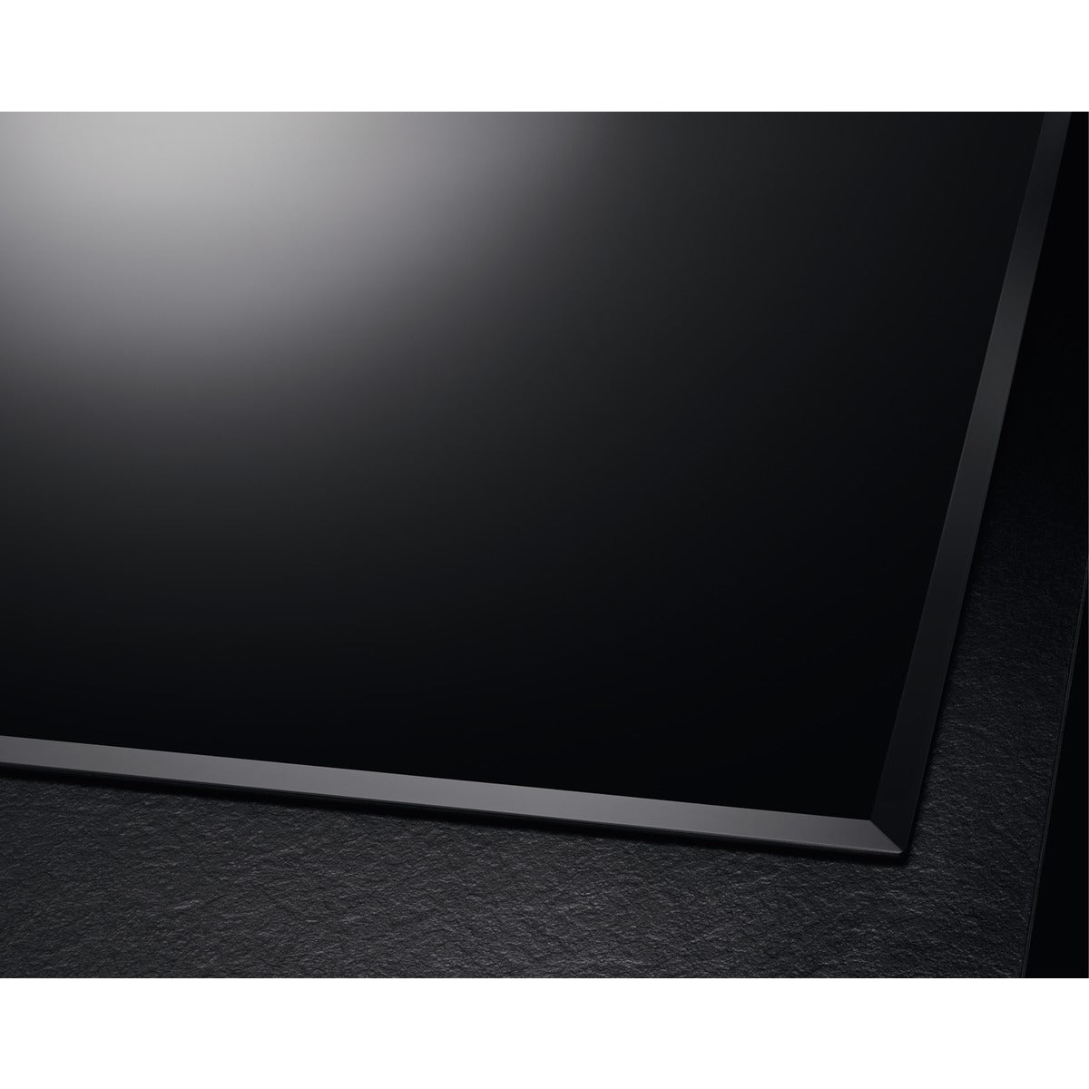 Black rectangular object on a textured black surface