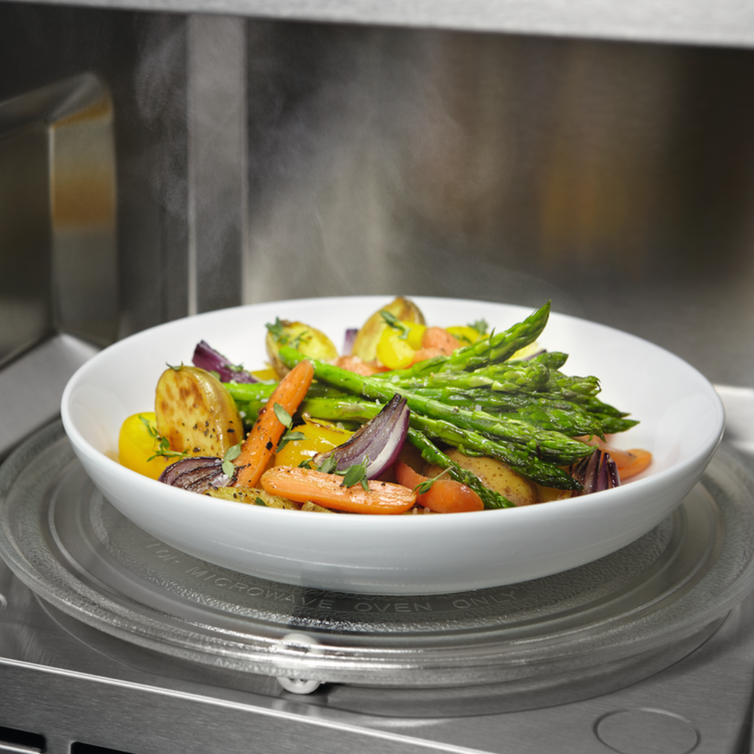 White bowl of roasted vegetables in a Electrolux Microwave