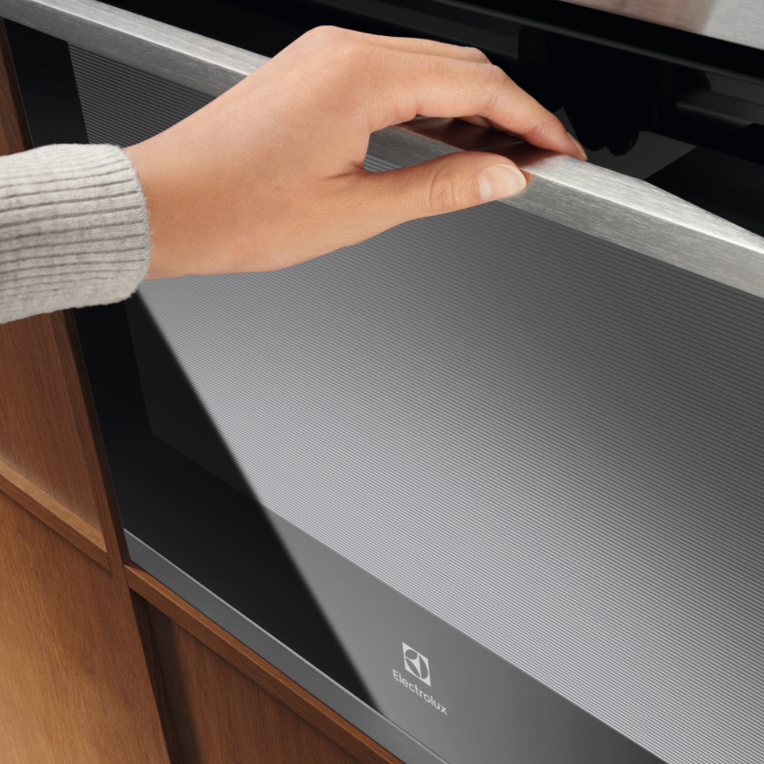 Hand opening a Electrolux 300 Series Multifunction Oven Stainless Steel door