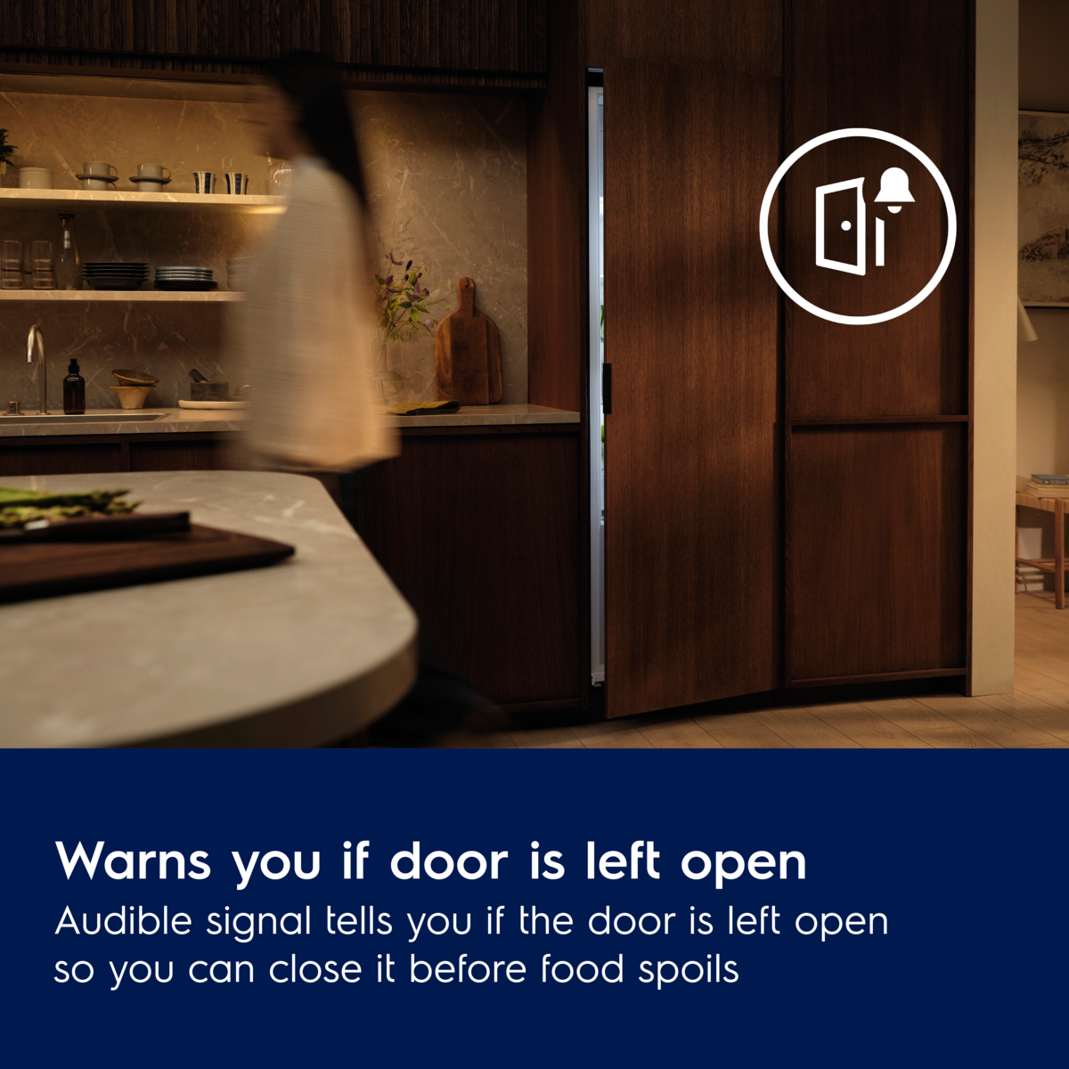 Kitchen scene with an electrolux Integrated Freezer and a person, featuring a label about door open notifications.