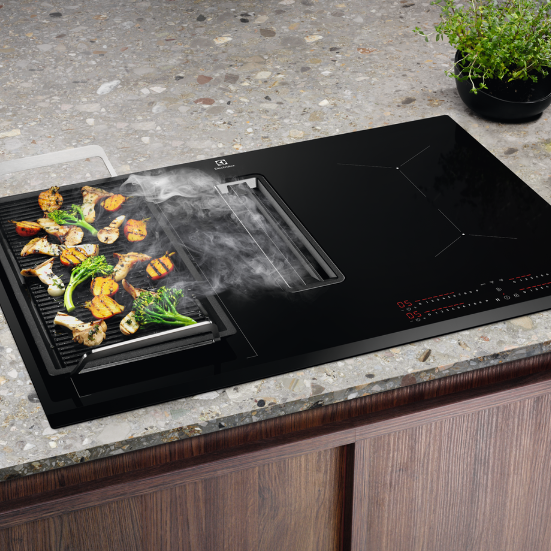 Electrolux Black Extraction induction Hob with a grill pan on a kitchen counter