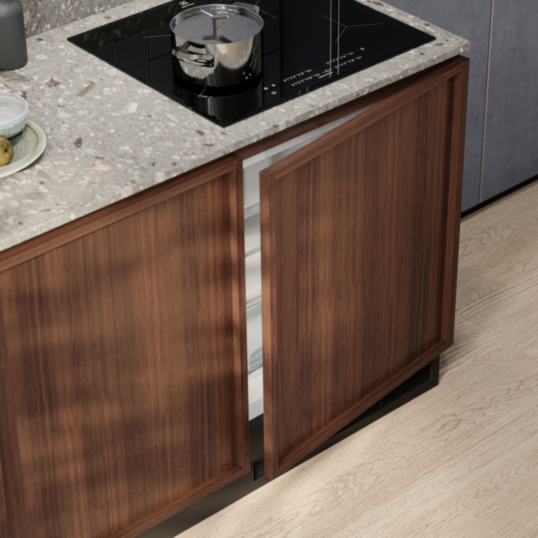 Wooden kitchen cabinet with granite countertop and built-in Electrolux Fridge.