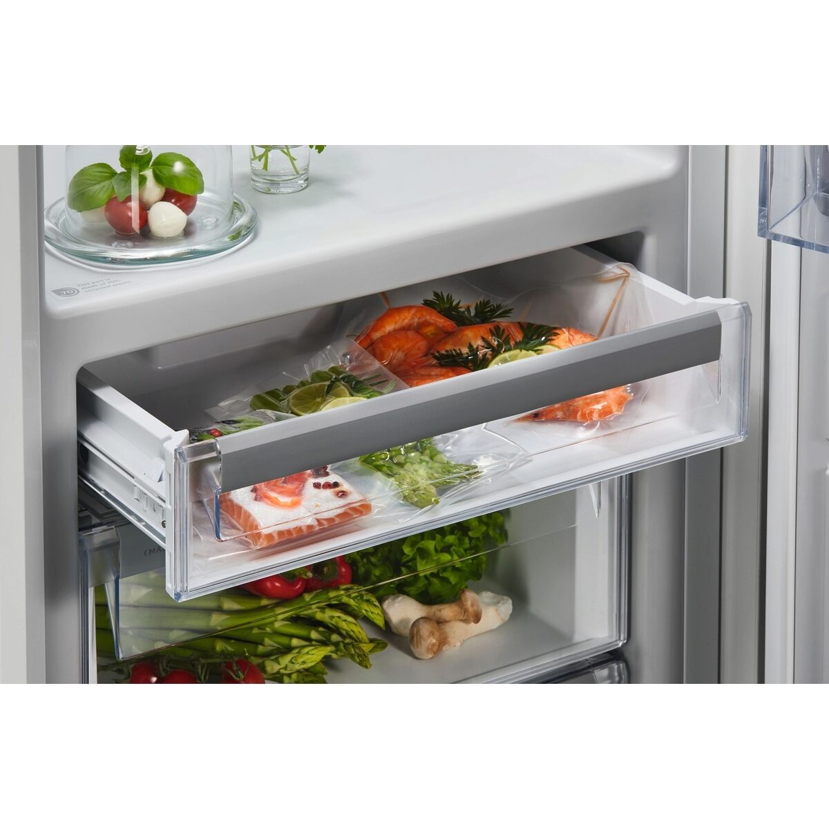 Open AEG refrigerator drawer with fresh produce inside