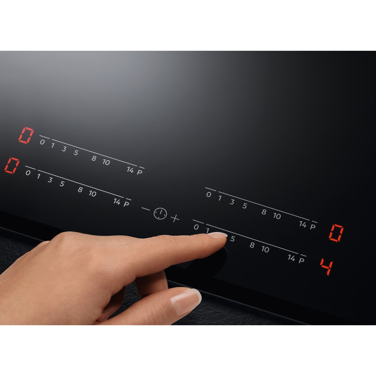 Hand adjusting settings on an AEG blackInuction Hob with digital display