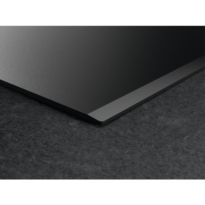 Black metal sheet on a textured black surface